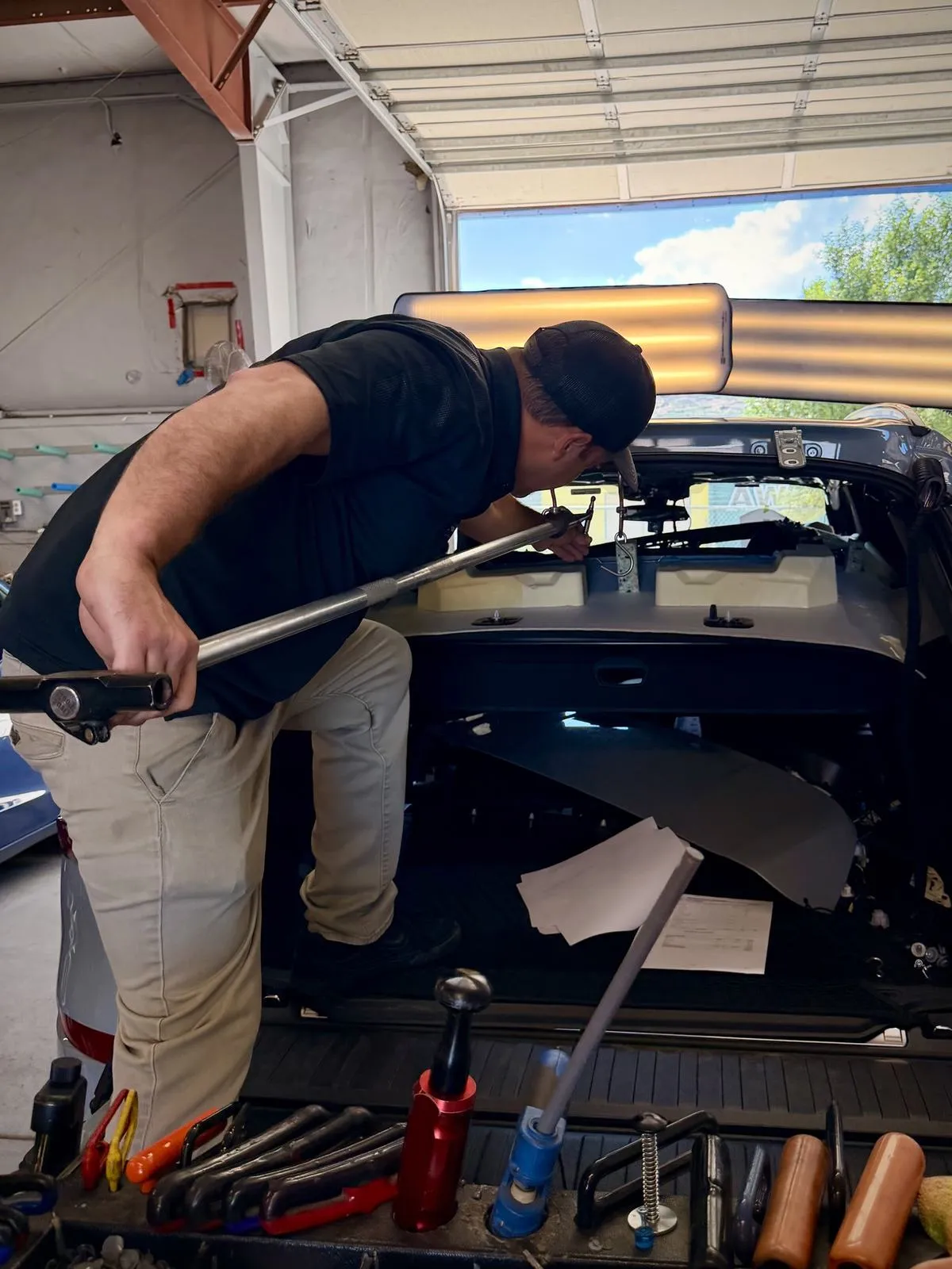 Tech working a dent from inside a door