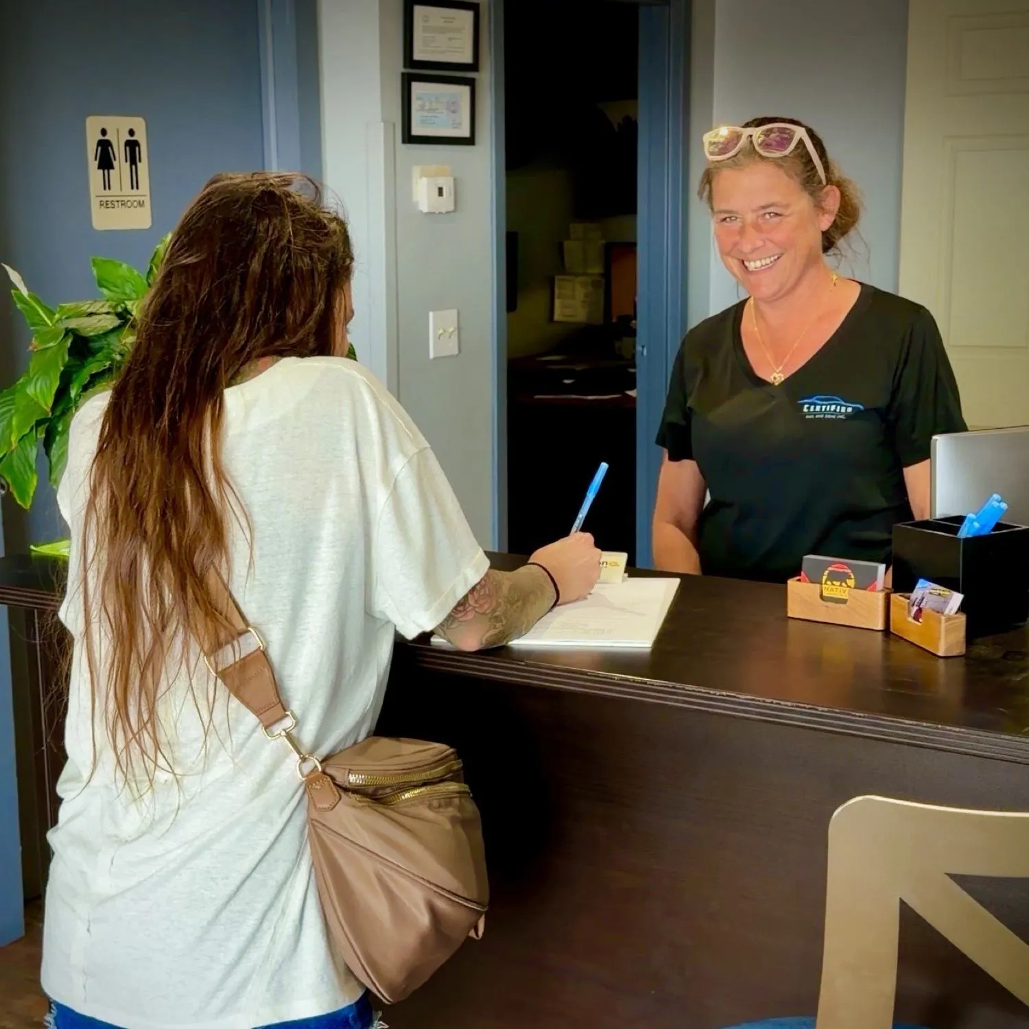 Sadie at the front desk with a customer