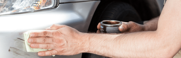 Man applying polish for car scratch repairs