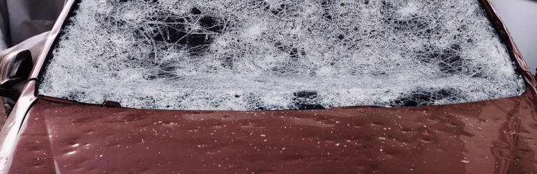 Hail damage to a car. Large hailstones have completely destroyed a car