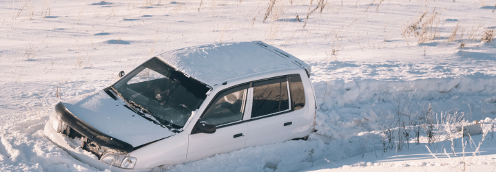 Protecting Your Vehicle Finish During Colorado Winters Feature Image: Car stuck in snow.