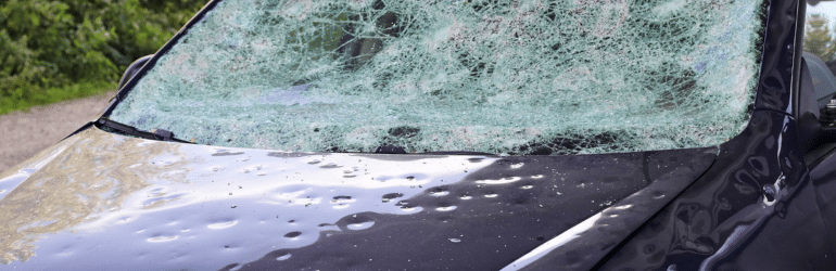 Hail damage to a car. Large hailstones have completely destroyed a car