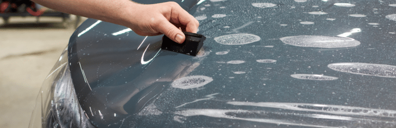 Installation of a protective paint and varnish transparent film on the car