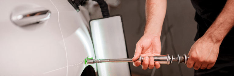 Repairing car dent after the accident by paintless dent repair